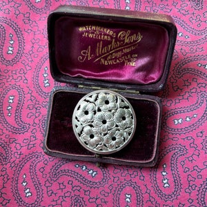 Pretty silver brooch in a mid century floral design.