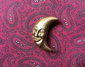 Vintage gold tone crescent man in the moon brooch.