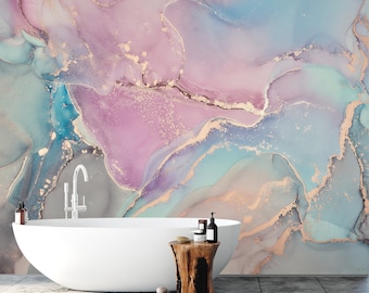 May include: A white freestanding bathtub sits in front of a wall mural featuring an abstract alcohol ink design in shades of soft pink, teal, and blue, accented with metallic gold veins. A wooden stool holds toiletries next to the tub.