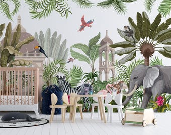 May include: A nursery room featuring a jungle-themed wall mural with an elephant, zebra, monkey, toucan, and parrot amidst palm leaves and architectural structures. The room includes a light wood crib, a small table with two chairs, and a toy cart.