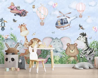 May include: A wall mural featuring watercolor illustrations of animals including a giraffe, elephant, zebra, bear, and koala in a jungle setting with airplanes and hot air balloons in a blue sky. A white wooden chair with rabbit ears sits in front.