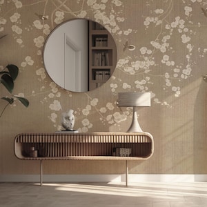 May include: A wooden console table with a slatted design and a shelf. The table is in a room with a beige wall featuring a floral wallpaper pattern. A round mirror hangs above the table, and a lamp sits on the table.