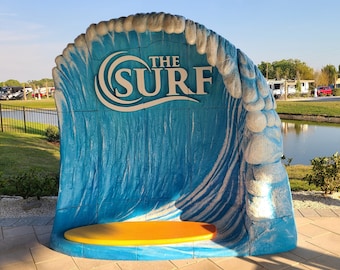 Surfing Wave Photo Op •  Jump on This Surf Board and Ride the Waves for a Fun Photo • Promote the Logo of the Business in Every Photo