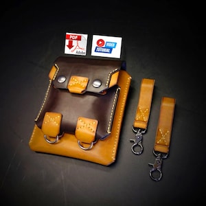 Pode incluir: Bolsa de couro artesanal em tons de castanho e bege com ferragens prateadas. Inclui dois chaveiros com mosquetões prateados. A bolsa tem um fecho de aba com dois botões de pressão prateados. Com ícones de PDF e tutorial em vídeo.