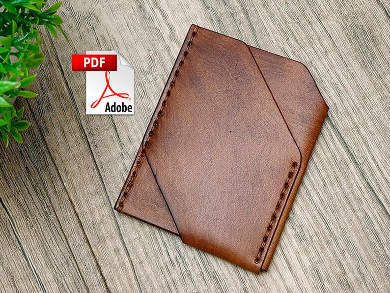 May include: A brown leather wallet with a stitched edge. The wallet has a flap that folds over the front.