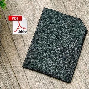May include: Black leather card holder with stitched edges. The card holder is on a wood surface. PDF Adobe.