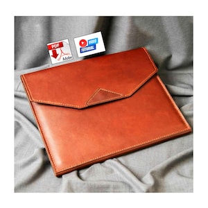 May include: A tan leather document case with a flap closure and a triangular detail. The rectangular case is made of leather and has visible stitching around the edges. The image also includes PDF and video tutorial icons.