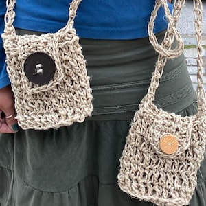 May include: Two small crocheted bags with straps, one with a brown button and the other with a wooden button.