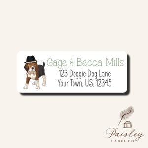May include: White rectangular label with a cartoon beagle wearing a hat and bow tie. The label includes the text "Gage & Becca Mills", address, and "Paisley Label Co." logo.