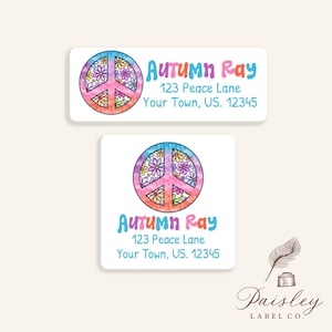May include: Two white address labels with a peace sign design. The peace sign is a circle with a vertical and two diagonal lines, filled with colorful flowers. The labels include the name "Autumn Ray" and address information.