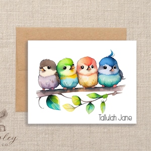 May include: A watercolor illustration of four colorful birds perched on a branch with green leaves. The birds are in shades of gray, green, orange, and blue. The text "Tallulah Jane" is below the birds.