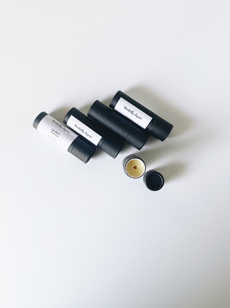 May include: Four black tubes of lip balm with white labels that read "Mindfully Organic" and "Lip Balm Peppermint". One tube is open and shows the lip balm inside.