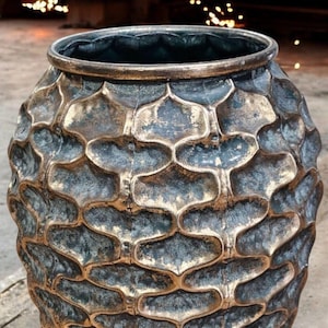 May include: A large, gold-coloured ceramic vase with a textured, honeycomb-like pattern. The vase is 44 cm tall and 28 cm wide.