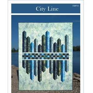 May include: A quilt with a city skyline design. The quilt features a blue and green color scheme with a geometric pattern of buildings and a checkered border. The quilt measures 56.5 inches by 70 inches.