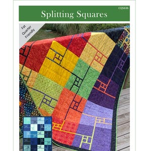 May include: A colorful quilt with a geometric design, featuring squares in shades of red, yellow, green, orange, and purple. The quilt has a black border and the text "Splitting Squares". The quilt is "Fat Quarter Friendly" and comes in 5 sizes, from small throw to king.