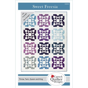 Pattern cover features quilt with 12 blue and purple starburst bloom blocks on a light background.