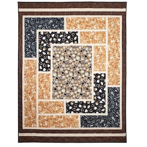 Sliding Screens Quilt.  Center panel featuring large-scale coffee themed print, bracketed by cream colored sashing and other coffee-themed fabrics in varying shades of brown.