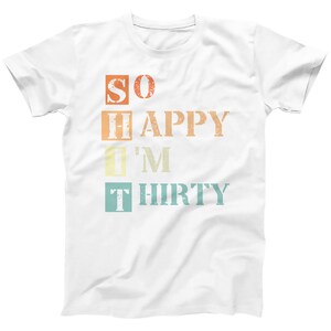 May include: White t-shirt with a vintage-style graphic that reads "SO HAPPY I'M THIRTY".