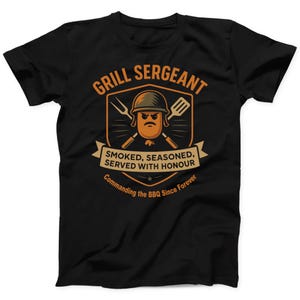 May include: Black t-shirt with a graphic design featuring a cartoon sausage wearing a helmet and holding grilling tools. The text reads "GRILL SERGEANT" and "SMOKED, SEASONED, SERVED WITH HONOUR". Below it says "Commanding the BBQ Since Forever".