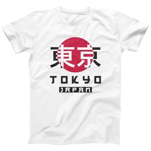 May include: White t-shirt with a red circle and black kanji characters that say "Tokyo" in English below the circle. The words "Japan" are printed in black below "Tokyo".
