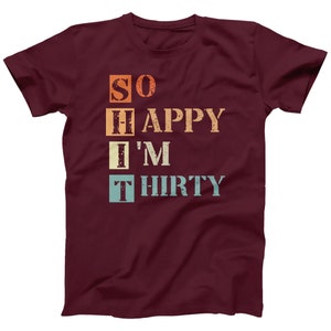 May include: A maroon t-shirt with a vintage-style graphic that reads "SO HAPPY I'M THIRTY".