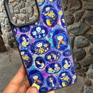 May include: Black phone case featuring a repeating pattern of cartoon characters in oval frames. The design includes characters with blue hair, wearing yellow and orange clothing, set against a purple and blue background. The case has a black border.