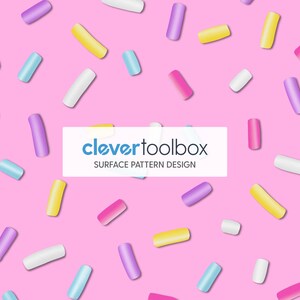 May include: A repeating surface pattern design featuring scattered, cylindrical sprinkles in shades of yellow, blue, pink, purple, and white against a solid pink background. A white rectangular overlay displays the text clevertoolbox SURFACE PATTERN DESIGN.