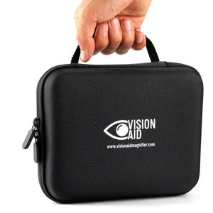 May include: Black zippered carrying case with a handle. The case has a white logo that says "VISION AID" and "www.visionaidmagnifier.com".