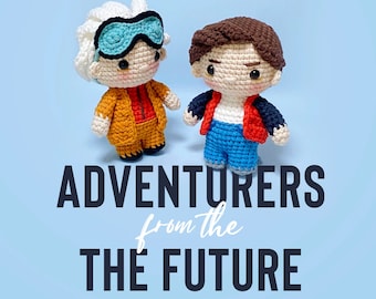 May include: Two crocheted dolls, one with white hair, blue goggles, and an orange outfit, and the other with brown hair, a red jacket, and blue pants. The text "ADVENTURERS from the FUTURE FUN SIZE" is displayed below the dolls on a blue background.