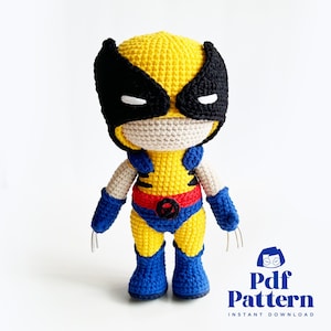 May include: Crocheted amigurumi toy of Wolverine from the X-Men. The toy is yellow with blue and red accents. It has a black mask with white eyes. The toy is standing on a white background.  Pdf Pattern Instant Download.