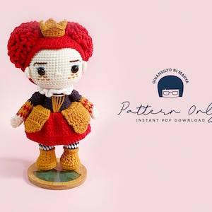 May include: Crochet pattern for a red-haired doll wearing a red and gold dress with a crown. The pattern is available as an instant PDF download. The text "Ginansilyo ni Marya Pattern Only Instant PDF Download" is visible in the image.