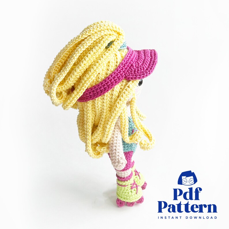 May include: Crochet pattern for a doll wearing a pink and yellow hat, a blue and green top, and roller skates. The pattern is available as an instant download.