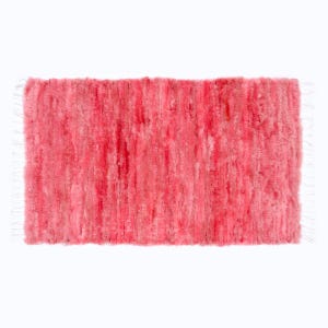 May include: A rectangular, plush rug in shades of pink. The rug has a textured surface with vertical lines and white fringe on the short ends. The rug appears soft and inviting.