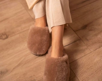 May include: A pair of brown fuzzy slippers with a closed toe and a soft, plush texture.