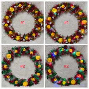 May include: Two Christmas wreaths decorated with red and green tinsel and yellow rubber duckies. The wreaths are numbered #1 and #2. One wreath has white snowflakes and the other has colorful lights.
