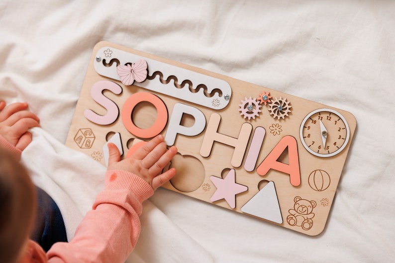 a child playing with a wooden name puzzle