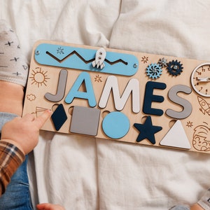 a child is playing with a wooden name puzzle
