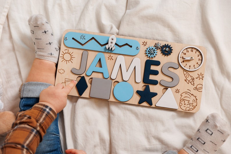 a child is playing with a wooden name puzzle