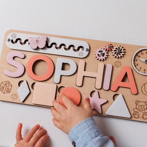 a child is playing with a wooden puzzle