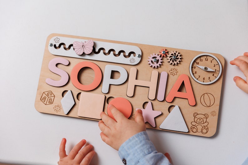 a child is playing with a wooden puzzle