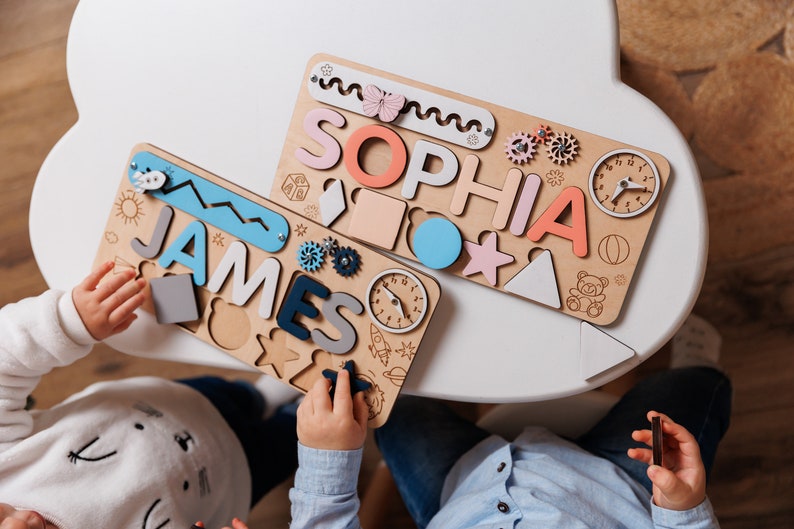 two children are playing with a wooden toy