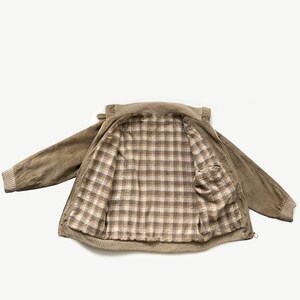 May include: A brown corduroy jacket with a plaid lining. The jacket has a zipper closure and two pockets.