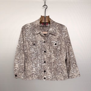 May include: A beige and brown snakeskin patterned jacket with a button-up front and long sleeves.