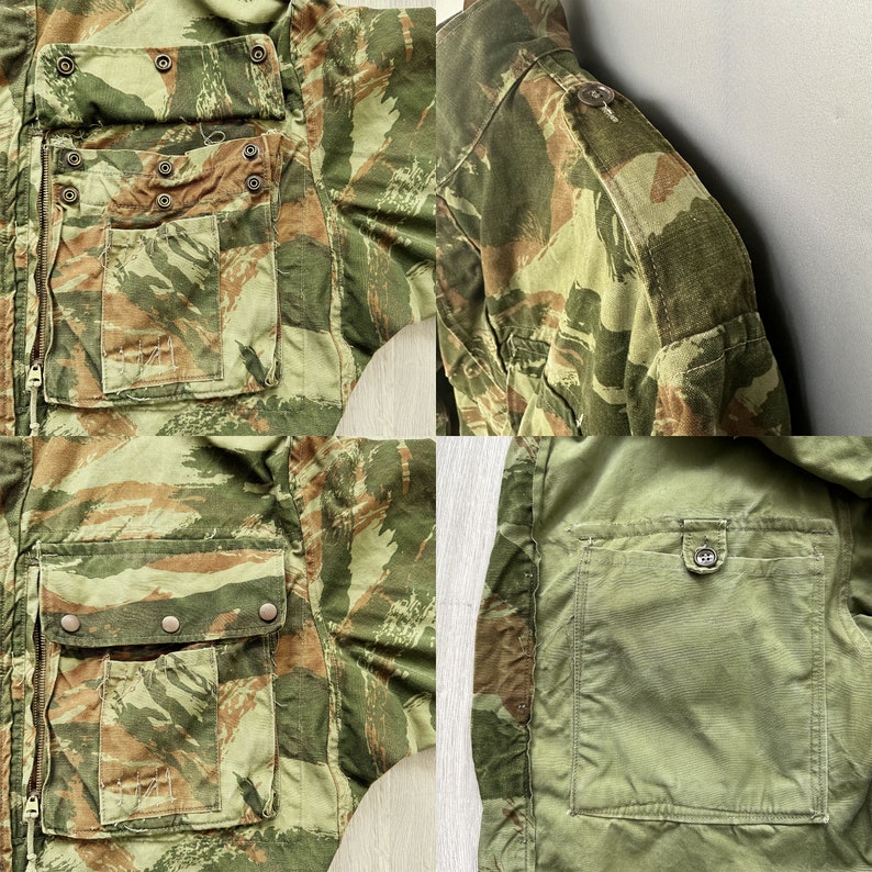 May include: A camouflage jacket with multiple pockets and a zipper closure. The jacket has a green, brown, and tan color scheme. The jacket is made of a durable fabric and has a classic design.