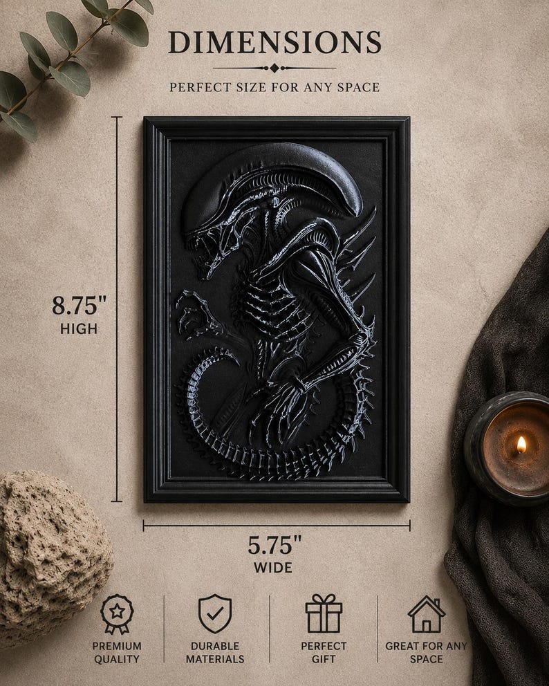 May include: Black framed relief sculpture of an Alien creature, 8.75 inches high and 5.75 inches wide. The artwork is a detailed depiction of the creature's form. The text "DIMENSIONS" and "PERFECT SIZE FOR ANY SPACE" are visible.