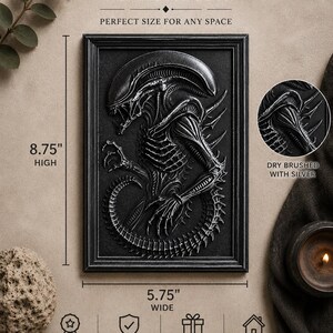 May include: Black framed wall art featuring a detailed relief of an alien creature. The artwork is 8.75 inches high and 5.75 inches wide. The text "DIMENSIONS" and "PERFECT SIZE FOR ANY SPACE" are at the top. The artwork is dry brushed with silver.