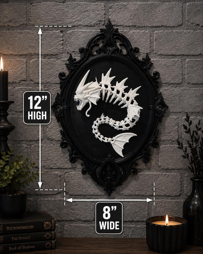 May include: A white skeletal sea creature sculpture mounted inside an ornate black oval frame. The wall art measures 12 inches high and 8 inches wide. The creature features a detailed skull, fins, and a curved spine, creating a stark contrast against the black background of the frame.