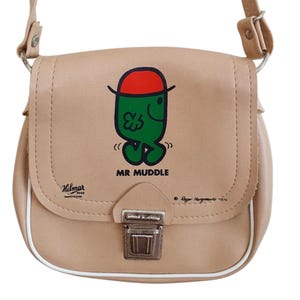 May include: A tan faux leather satchel bag with a white trim. The bag features a Mr. Men character, Mr. Muddle, wearing a red hat. The bag has a silver clasp and a Hilmar label.