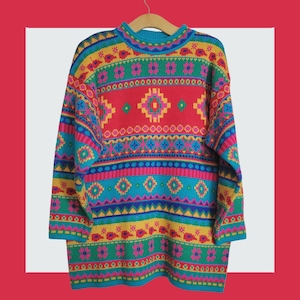 May include: A brightly coloured vintage sweater with a high neck and long sleeves. The sweater displays a vibrant geometric pattern in red, turquoise, yellow, pink, and green. The design includes floral and diamond shapes, creating a bold and eye-catching look.