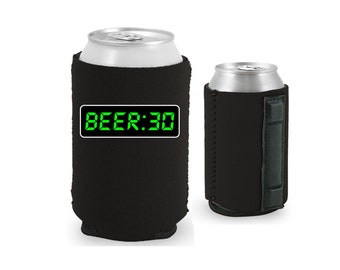 May include: Black neoprene can cooler with a green digital display that reads "BEER:30".